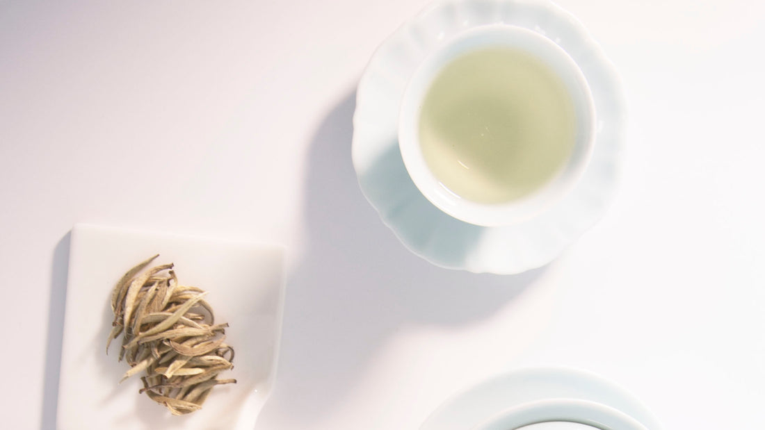 a little cup of kung fu brew white tea and some loose leaves